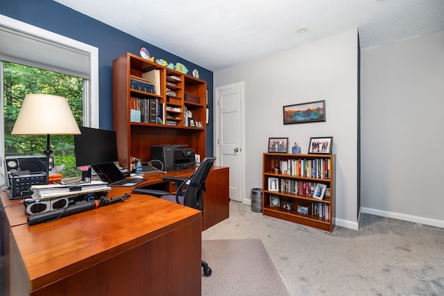 home office with a textured ceiling, baseboards, and carpet floors