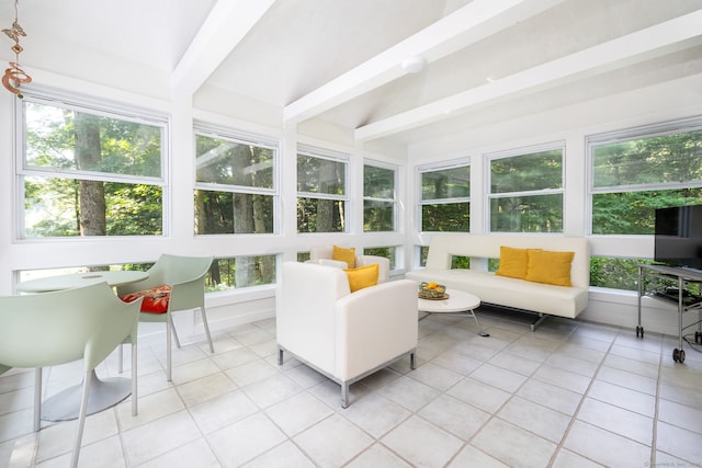 sunroom featuring beam ceiling