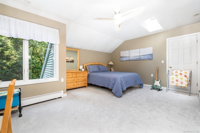 carpeted bedroom with lofted ceiling with skylight, baseboards, baseboard heating, and ceiling fan