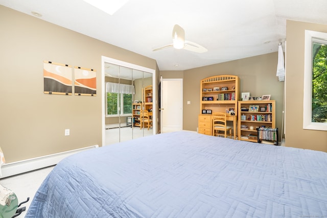 bedroom with a baseboard heating unit and a ceiling fan