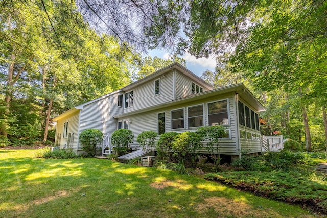 47 Jeremy River Dr, Colchester, CT 06415 - back of property featuring a yard and a sunroom