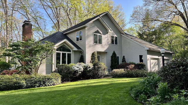 47 Jeremy River Dr, Colchester, CT 06415 - view of front of property featuring a chimney, an attached garage, a front lawn, and a shingled roof