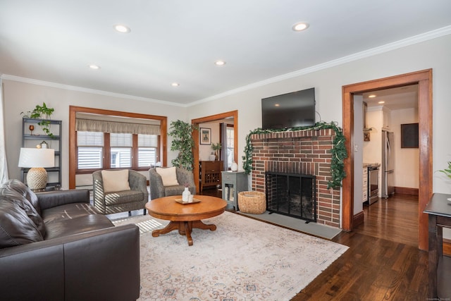 living room with crown molding, a brick fireplace, recessed lighting, and dark wood-style flooring