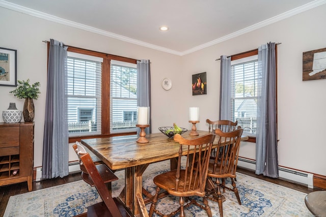 dining space featuring ornamental molding, a baseboard radiator, a baseboard heating unit, and wood finished floors