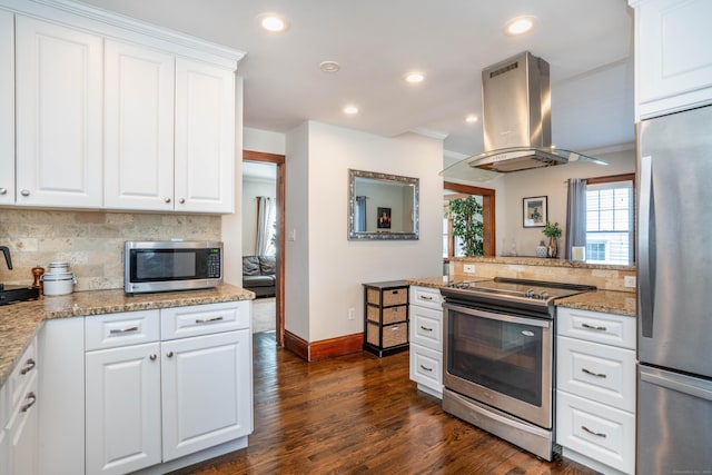 kitchen with decorative backsplash, appliances with stainless steel finishes, island exhaust hood, dark wood-style floors, and white cabinetry