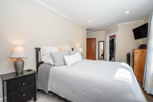 bedroom with ornamental molding, wood finished floors, recessed lighting, a closet, and a spacious closet