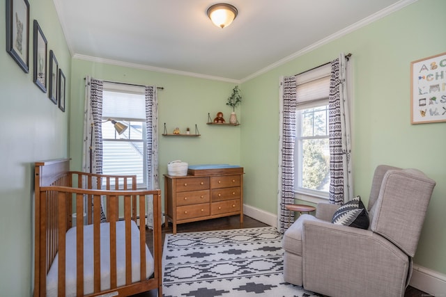 bedroom with wood finished floors, baseboards, and ornamental molding