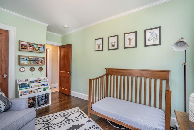 bedroom featuring baseboards, wood finished floors, and ornamental molding