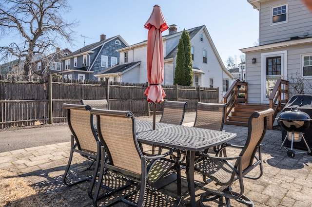 view of patio / terrace with outdoor dining area, a residential view, fence private yard, and grilling area