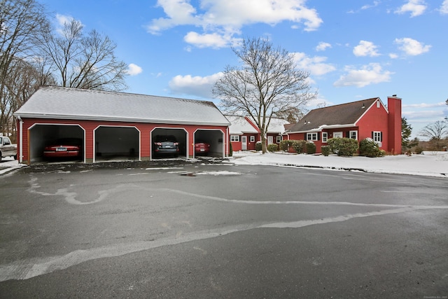 view of car parking with a garage and driveway