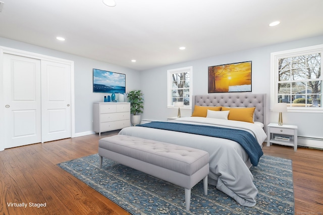 bedroom with recessed lighting, wood finished floors, a closet, and baseboards