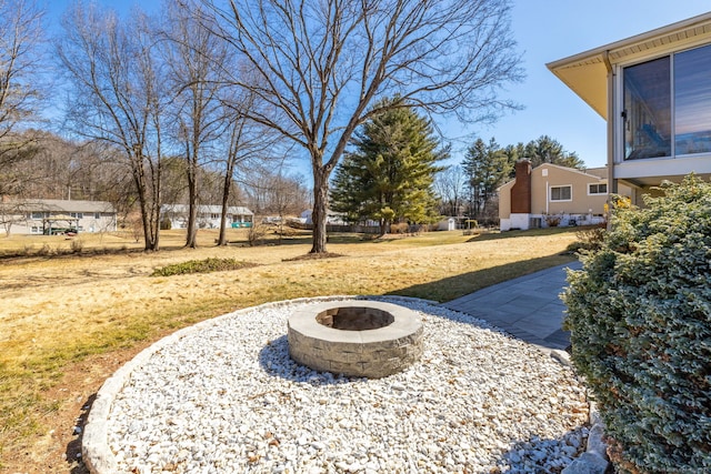 view of yard with a fire pit