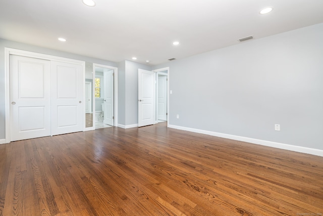 unfurnished bedroom with recessed lighting, visible vents, baseboards, and dark wood-style flooring