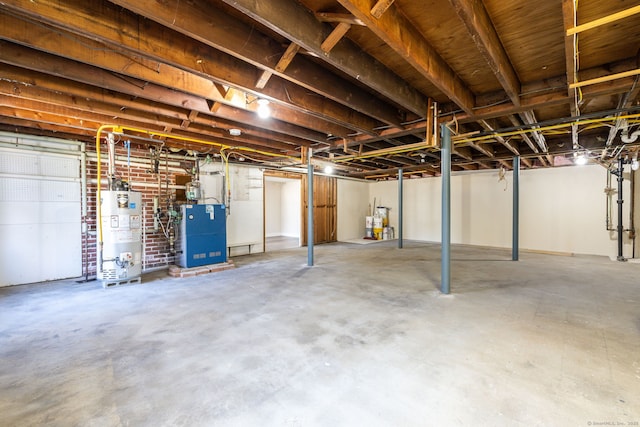 unfinished basement with gas water heater and a heating unit