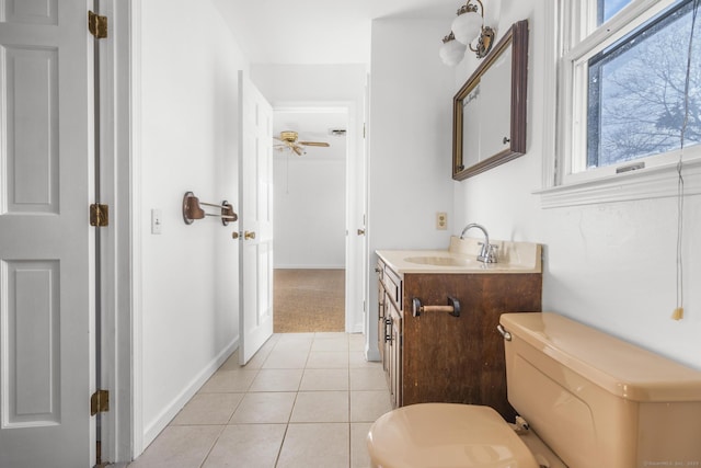 bathroom featuring tile patterned floors, baseboards, toilet, and vanity