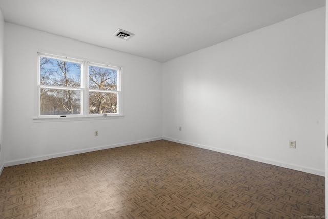 empty room with visible vents and baseboards