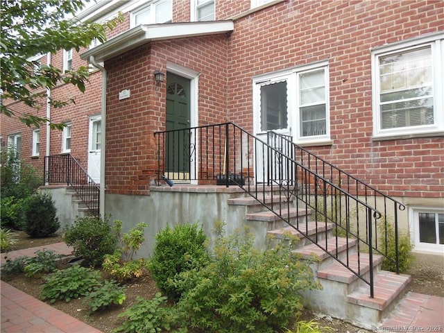 property entrance featuring brick siding