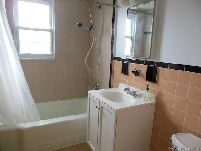 bathroom featuring toilet, tile walls, vanity, and shower / bathtub combination with curtain