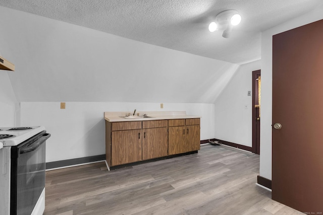 bonus room with baseboards, a textured ceiling, light wood-style flooring, and vaulted ceiling