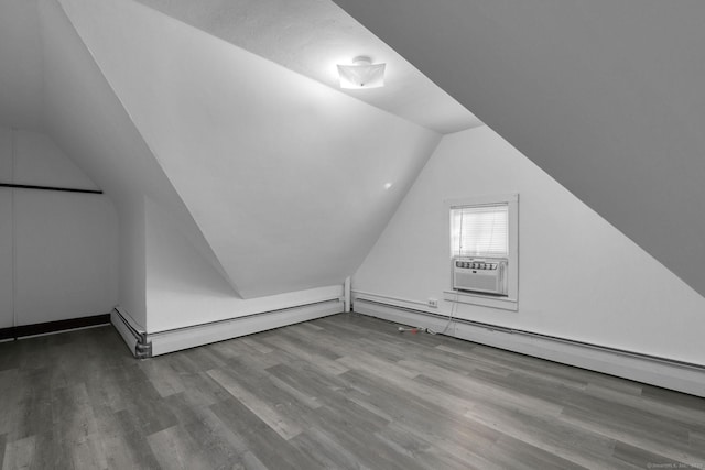 bonus room with wood finished floors, lofted ceiling, and a baseboard radiator