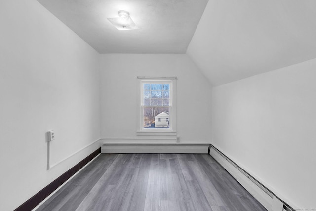 bonus room featuring baseboards, lofted ceiling, baseboard heating, and wood finished floors