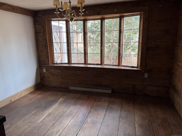 unfurnished room with a baseboard radiator, an inviting chandelier, and hardwood / wood-style flooring