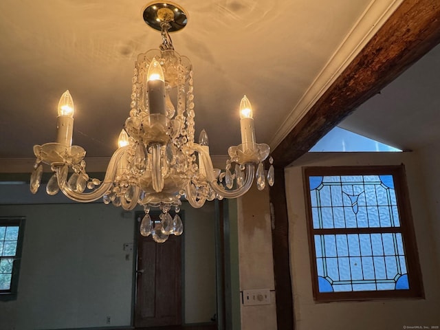 details featuring a notable chandelier and crown molding