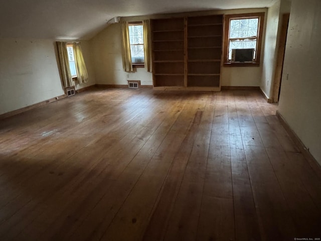 bonus room featuring visible vents, lofted ceiling, and hardwood / wood-style floors