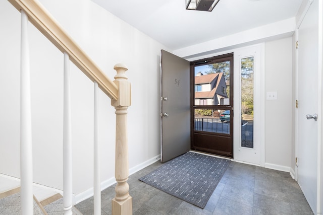 entryway featuring baseboards and stairs