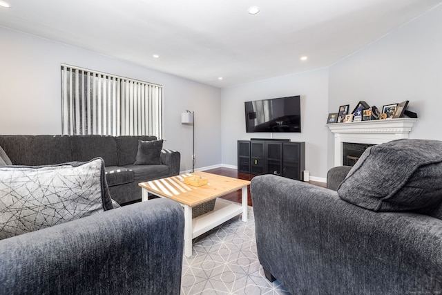 living area featuring recessed lighting, a fireplace, and baseboards