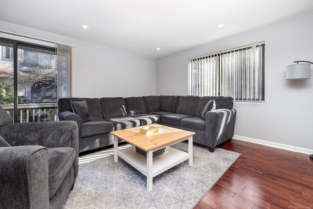 living room with a wealth of natural light, baseboards, wood-type flooring, and recessed lighting