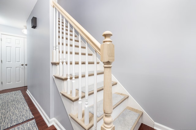 stairs featuring baseboards and wood finished floors