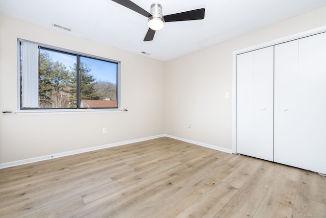 unfurnished bedroom with visible vents, baseboards, ceiling fan, light wood-style flooring, and a closet