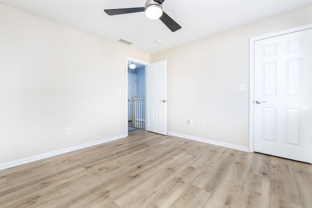 unfurnished bedroom featuring visible vents, baseboards, light wood-style floors, and a ceiling fan