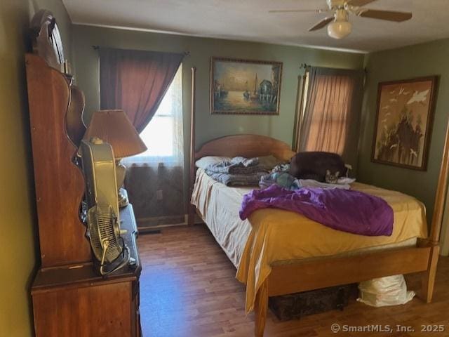 bedroom with wood finished floors and a ceiling fan