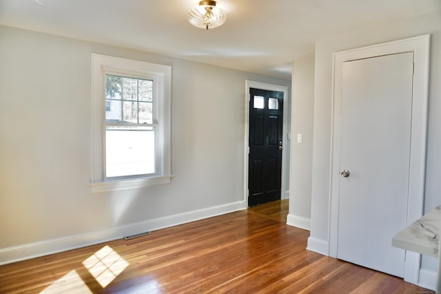 entryway with visible vents, baseboards, and wood finished floors