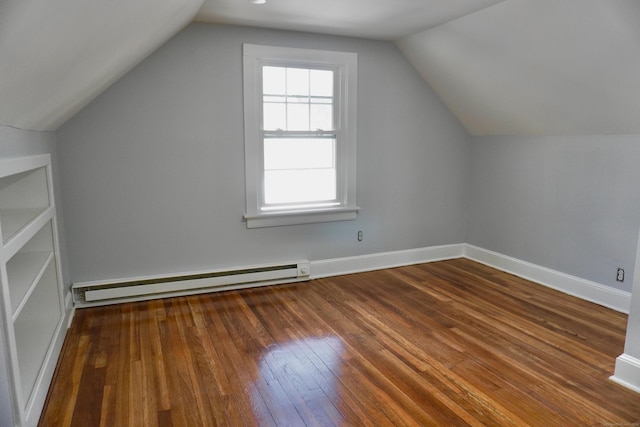 bonus room featuring a baseboard heating unit, hardwood / wood-style flooring, baseboards, and vaulted ceiling