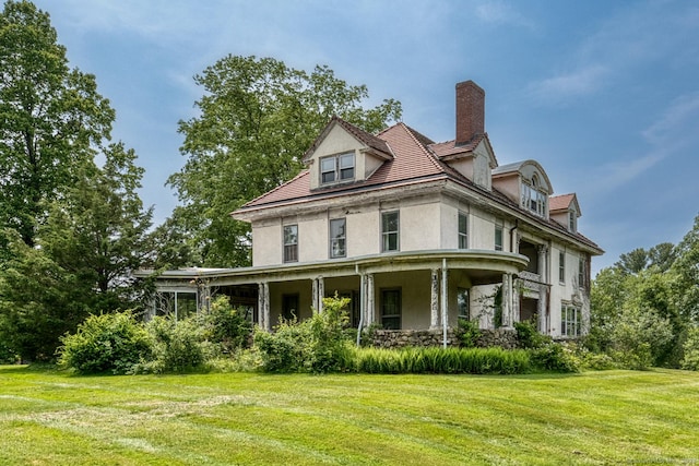 673 Spring St, Manchester, CT 06040 - view of front facade featuring stucco siding, a front lawn, and a chimney