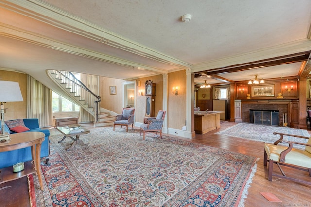 673 Spring St, Manchester, CT 06040 - living room featuring crown molding, plenty of natural light, a fireplace, stairway, and wood finished floors