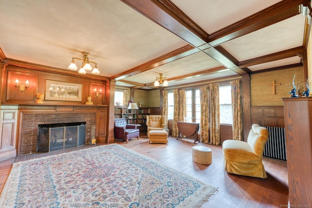 673 Spring St, Manchester, CT 06040 - living area with wood finished floors, crown molding, a brick fireplace, radiator, and beam ceiling