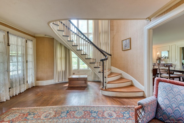 673 Spring St, Manchester, CT 06040 - stairs with wood finished floors, crown molding, wallpapered walls, and baseboards