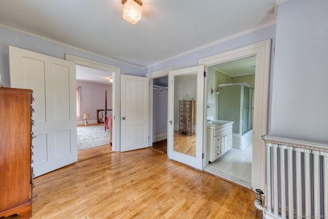 673 Spring St, Manchester, CT 06040 - unfurnished bedroom featuring light wood-style floors, ornamental molding, ensuite bathroom, baseboards, and a closet