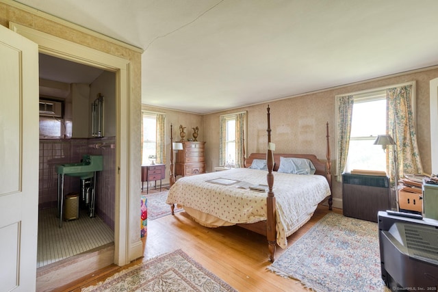 673 Spring St, Manchester, CT 06040 - bedroom with light wood-type flooring and multiple windows