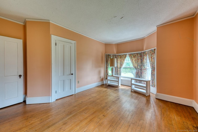 673 Spring St, Manchester, CT 06040 - empty room featuring a textured ceiling, ornamental molding, baseboards, and light wood-style floors