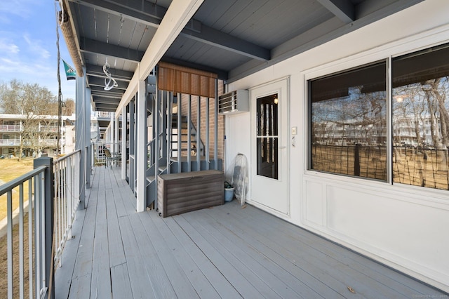 wooden deck featuring an AC wall unit and stairs