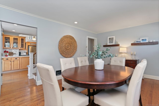 dining room featuring recessed lighting, baseboards, light wood-style floors, and ornamental molding