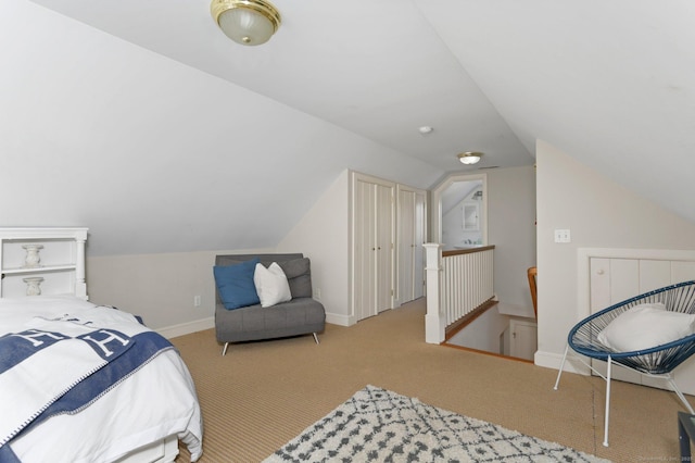 bedroom featuring baseboards, carpet, and vaulted ceiling