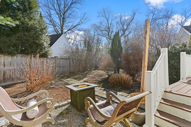 view of yard with a fire pit and fence