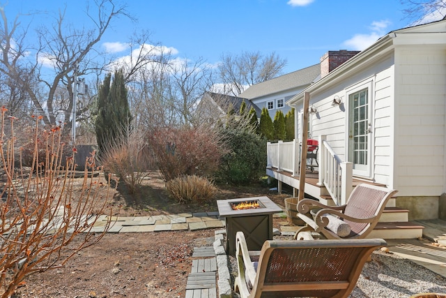 view of yard with a fire pit and a wooden deck