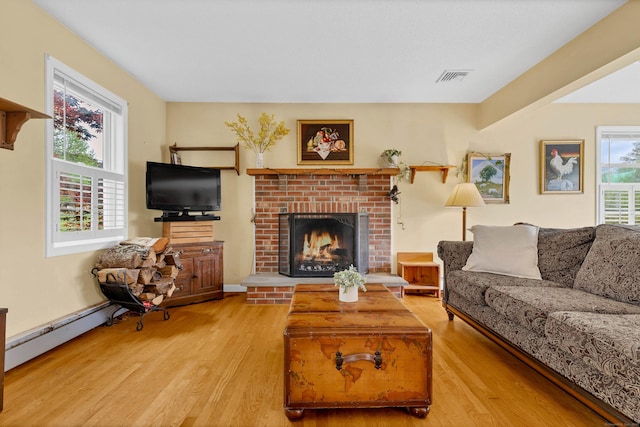 686 W Rd, Salem, CT 06420 - living area featuring wood finished floors, a fireplace, and a baseboard radiator